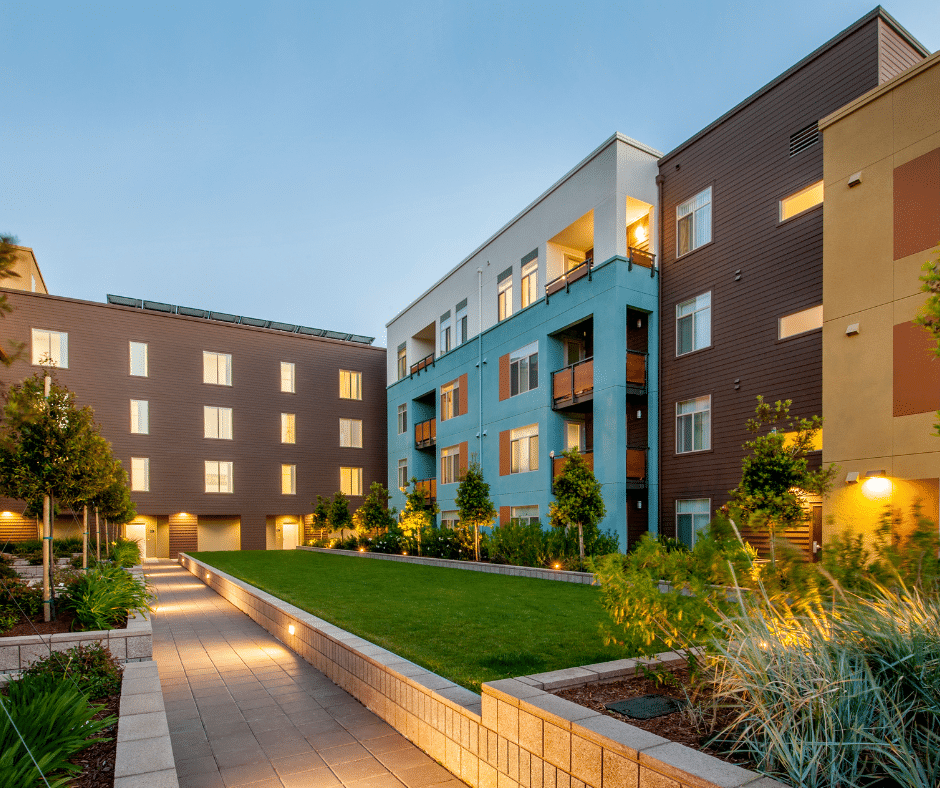 apartment building with green space at dusk