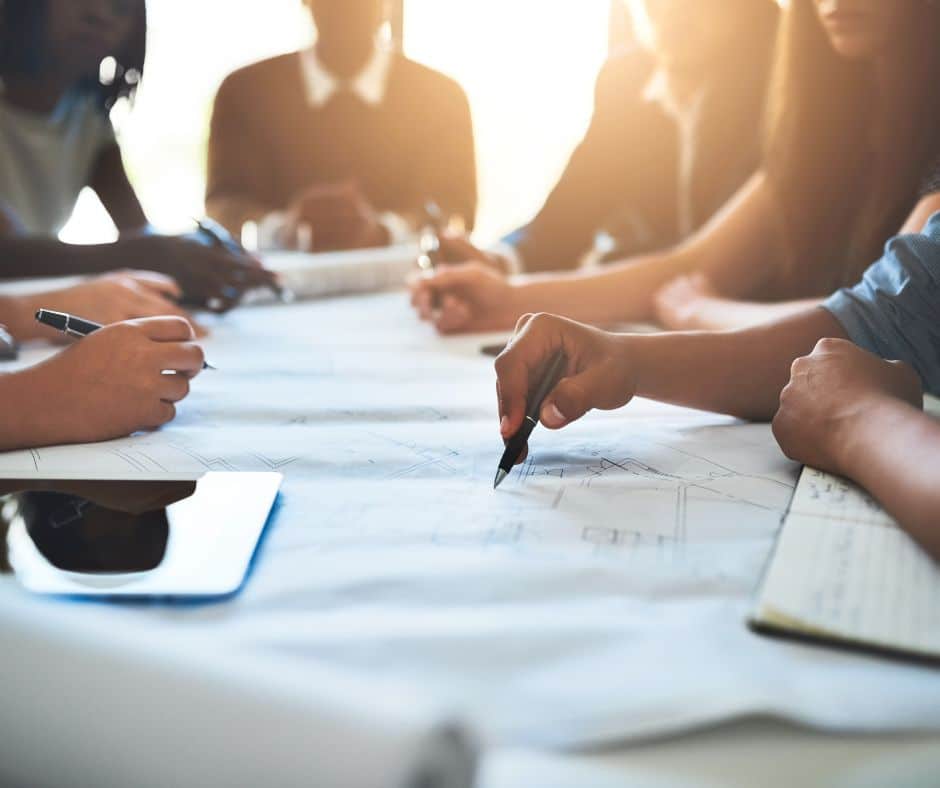 team of people reviewing blueprints