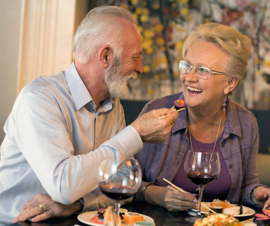 senior couple eating sushi