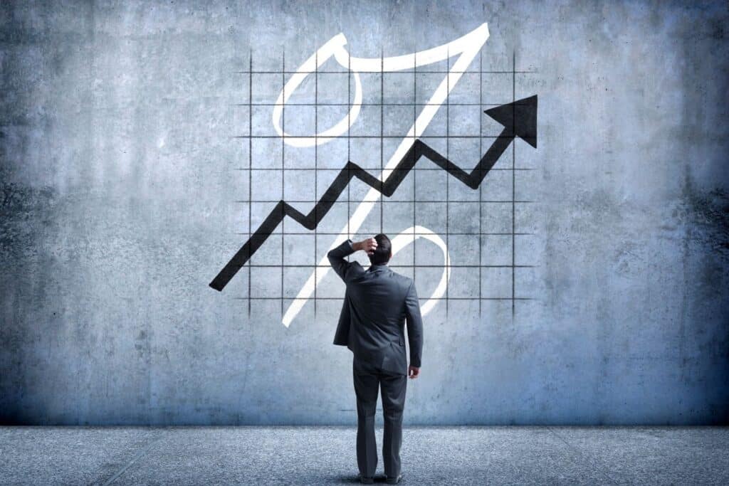 man looking at chart showing rising interest rates