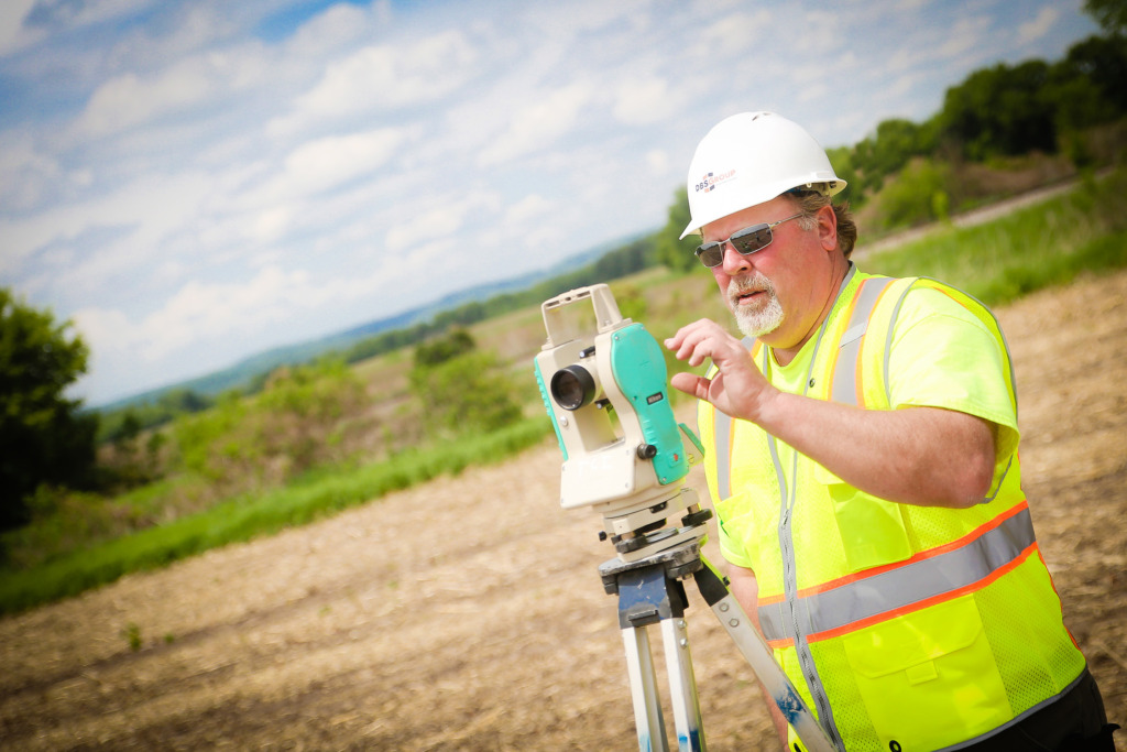 construction worker surveying vacant land