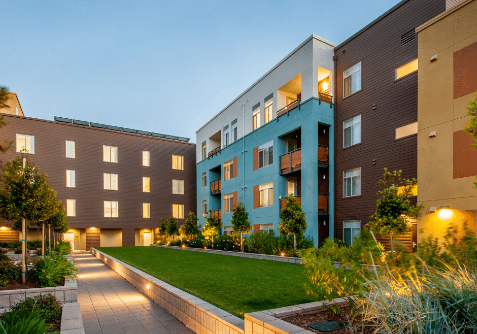 apartment building with green space at dusk