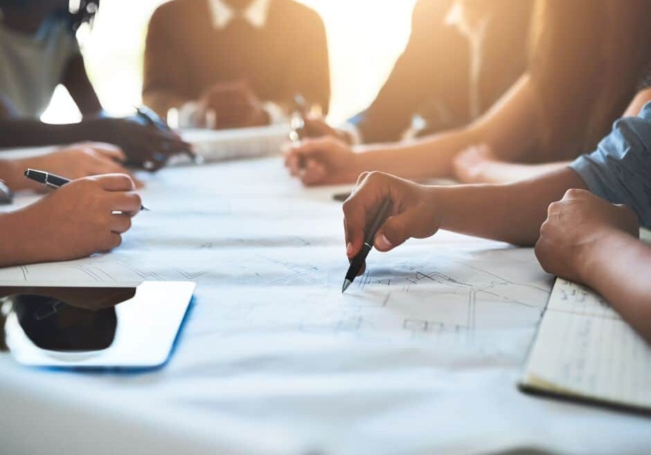 team of people reviewing blueprints