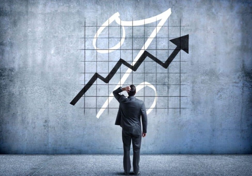 man looking at chart showing rising interest rates