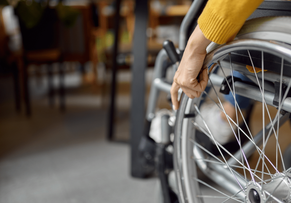 person in wheelchair pulling up to accessible table due to universal design