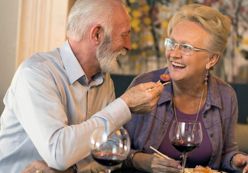 senior couple eating sushi